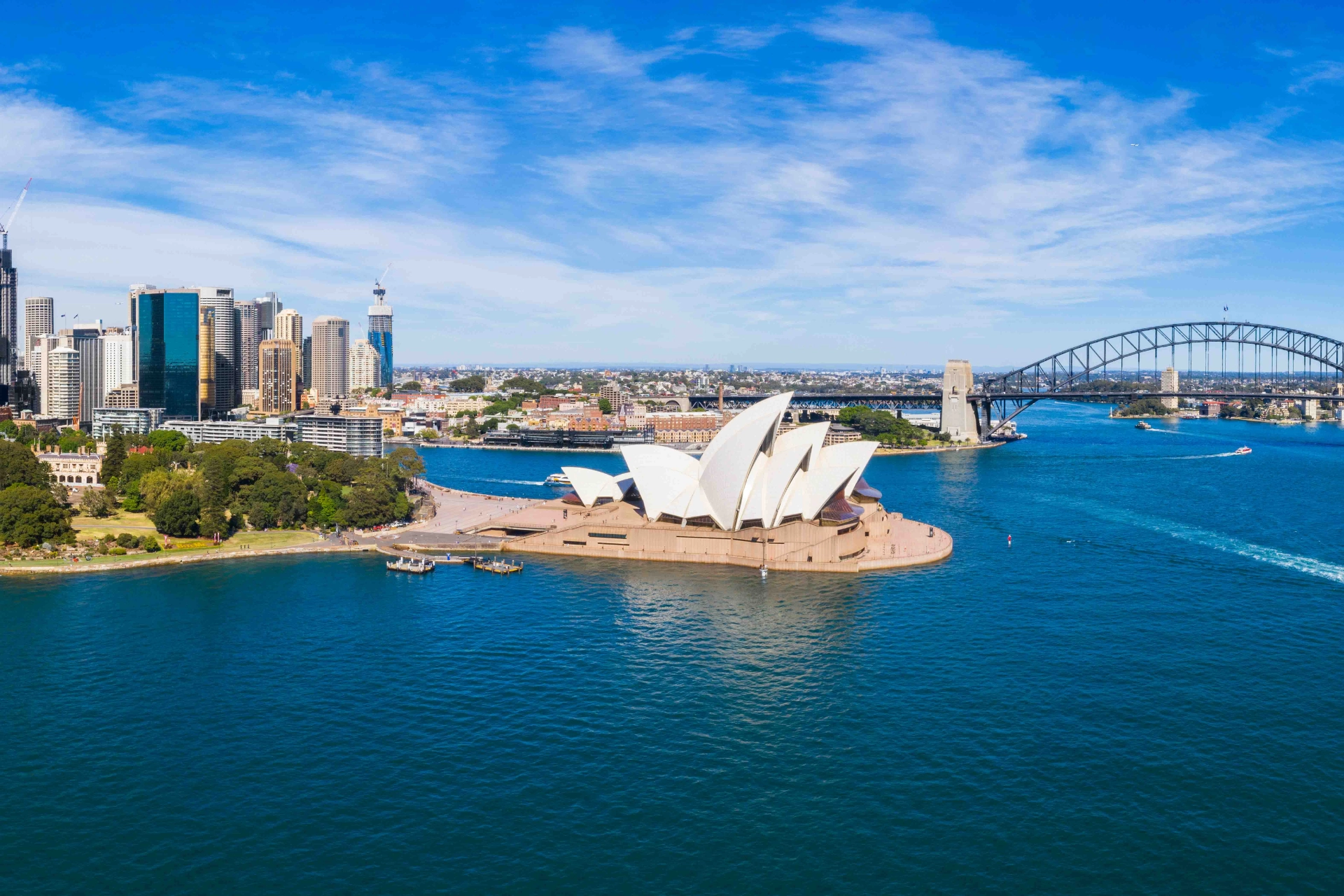Luftfoto av Sydney med havnebroen, Operaen og byens skyline