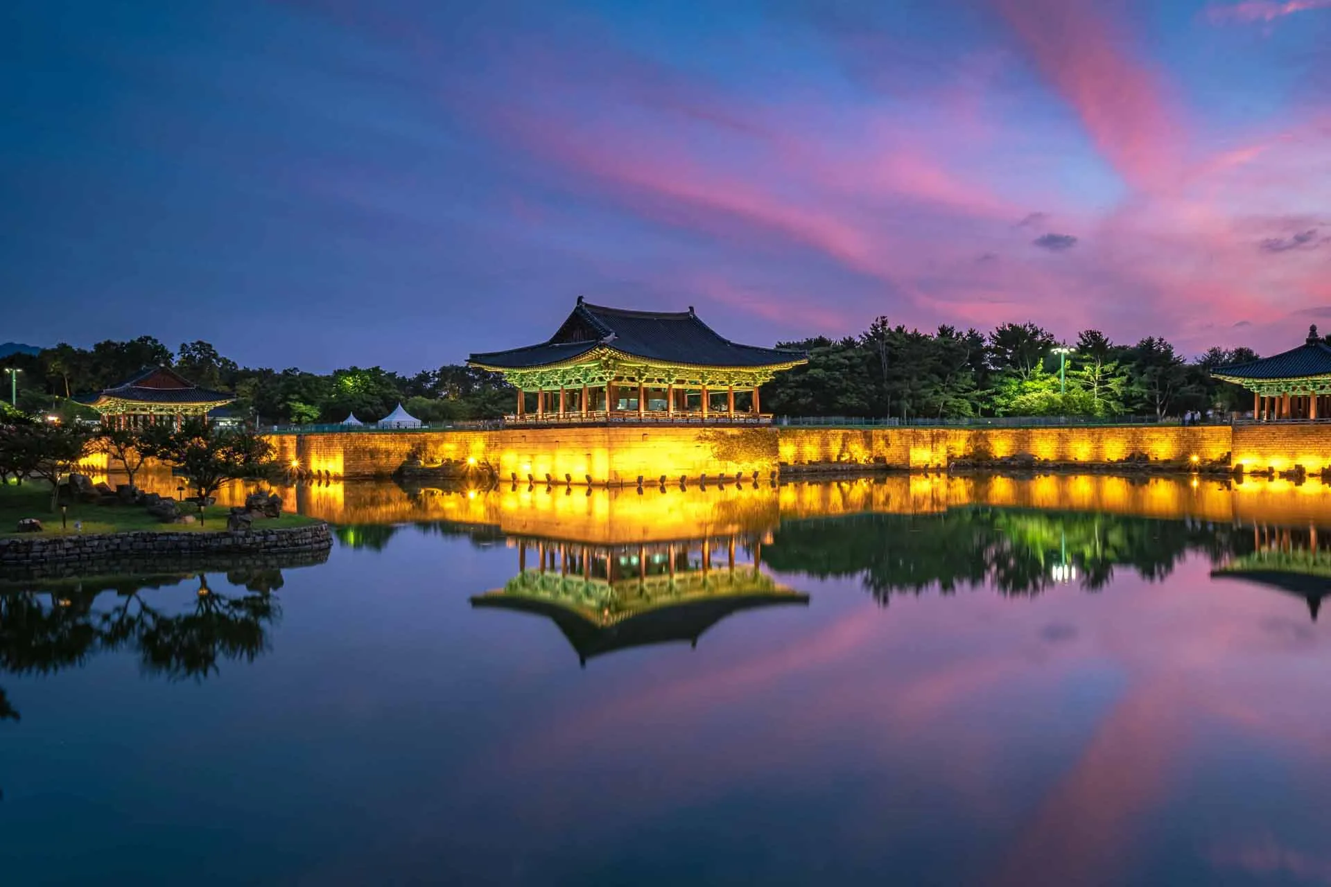 Donggung-palasset og Wolji-dammen i Gyeongju speiler seg vakkert i solnedgangen Donggung-palasset og Wolji-dammen i Gyeongju speiler seg vakkert i solnedgangen