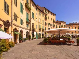 Torget Piazza dell’Anfiteatro med kafeer og gule hus
