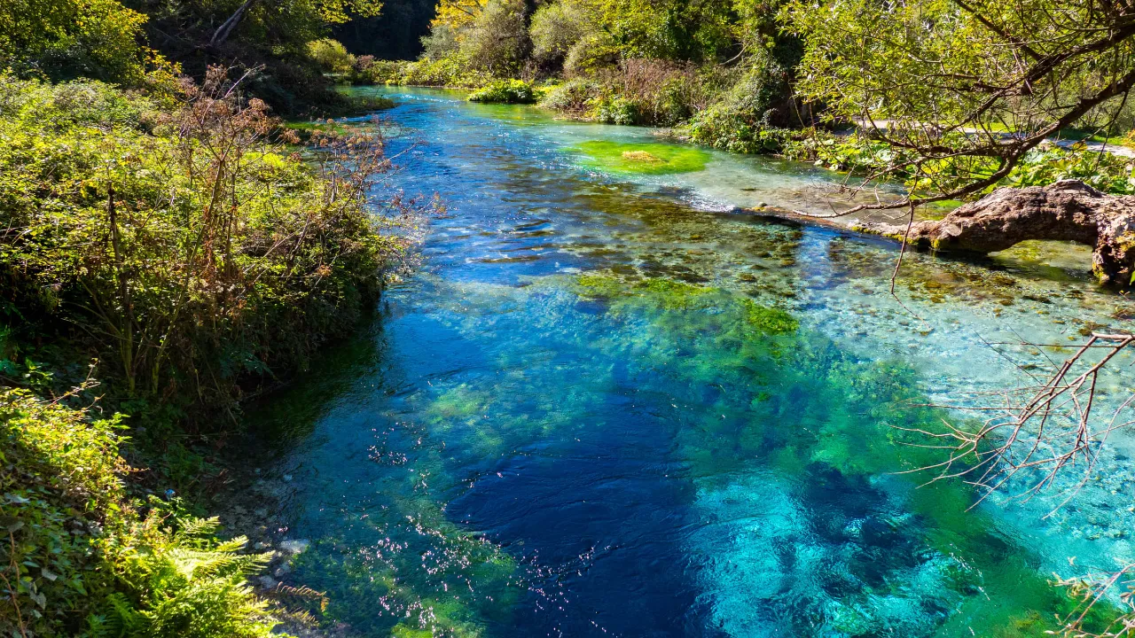 Syri i Kaltër (Det Blå Øyet), Albania – en naturskjønn kilde med krystallklart, turkisblått vann Syri i Kaltër (Det Blå Øyet), Albania – en naturskjønn kilde med krystallklart, turkisblått vann